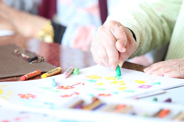 residents using crayons for their arts and crafts