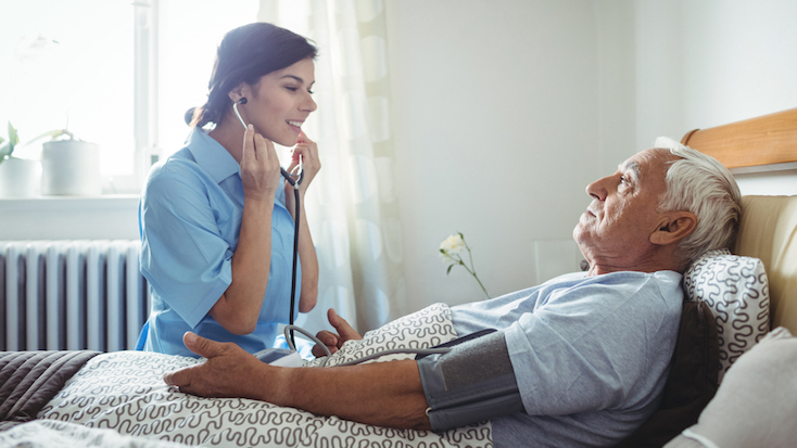 resident having heart rate taken by carer