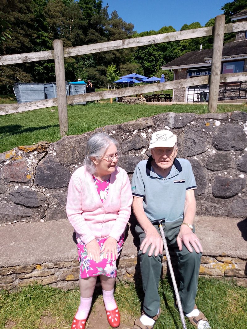 residents sat outside in the sun chatting