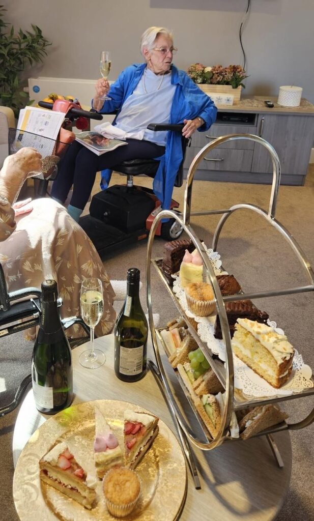 residents enjoying some cakes and sandwiches in our new community