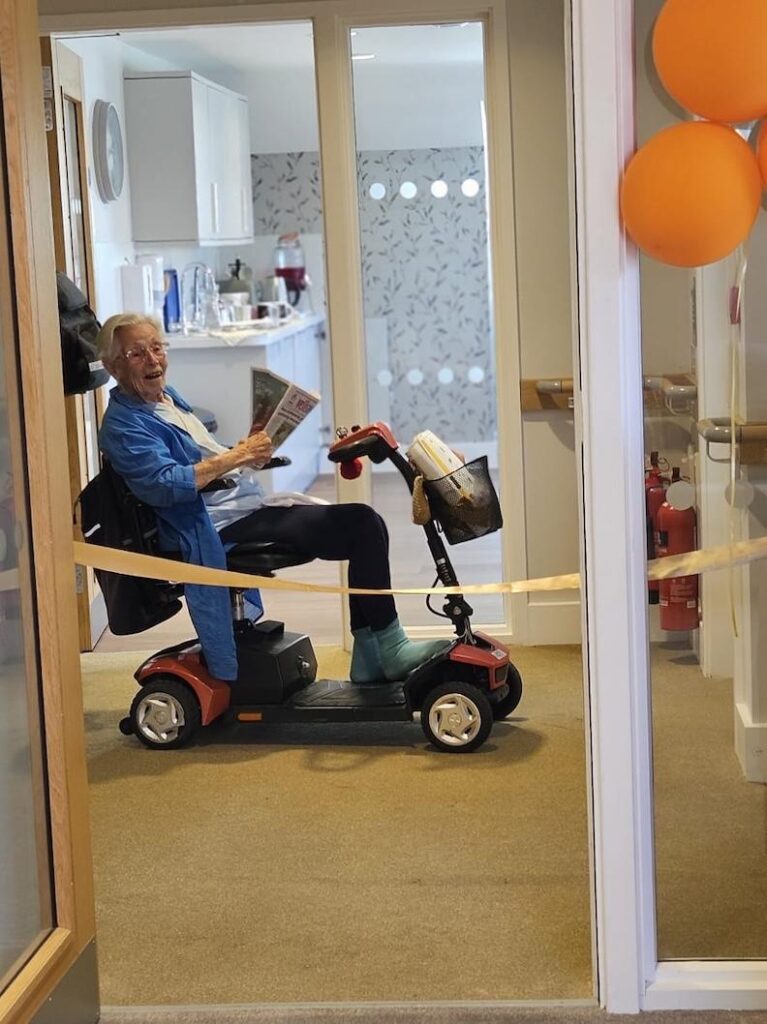 resident on a scooter by our new community