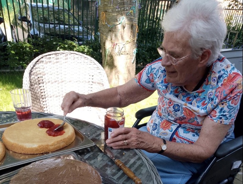 resident decorating cake with jam