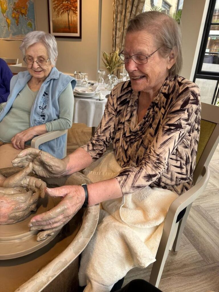 one of our female residents helping to make pottery