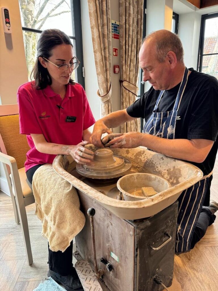 one of our team members making pottery