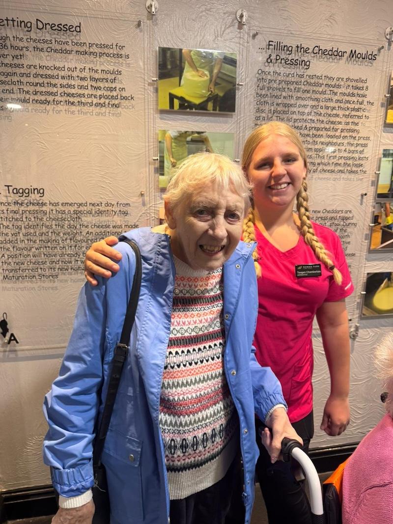 resident and carer smiling together at the cheese factory