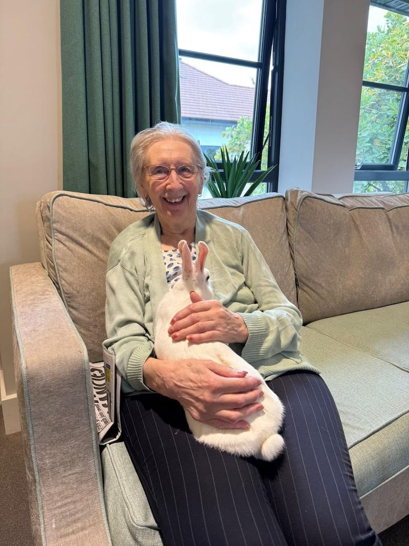 resident sat with a rabbit in her lap