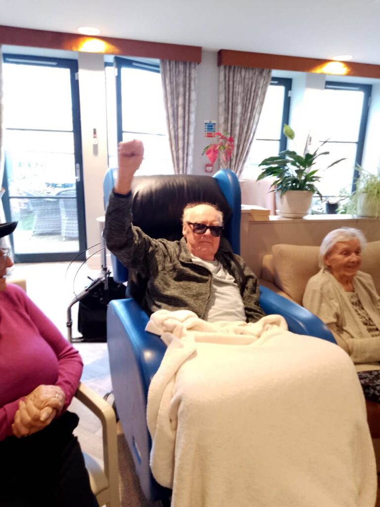 resident in chair with sunglasses