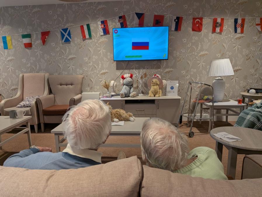 two residents looking at a tv