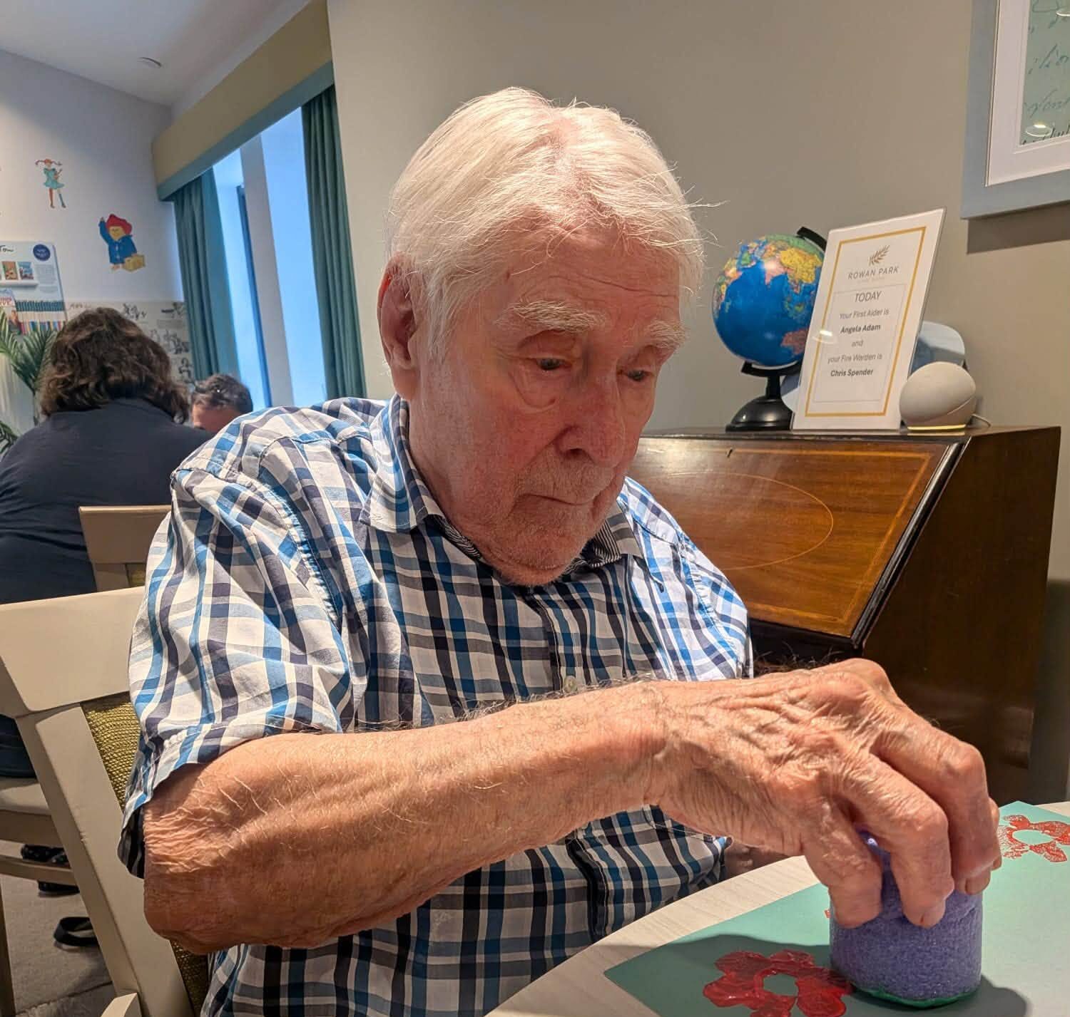 older man doing arts and crafts